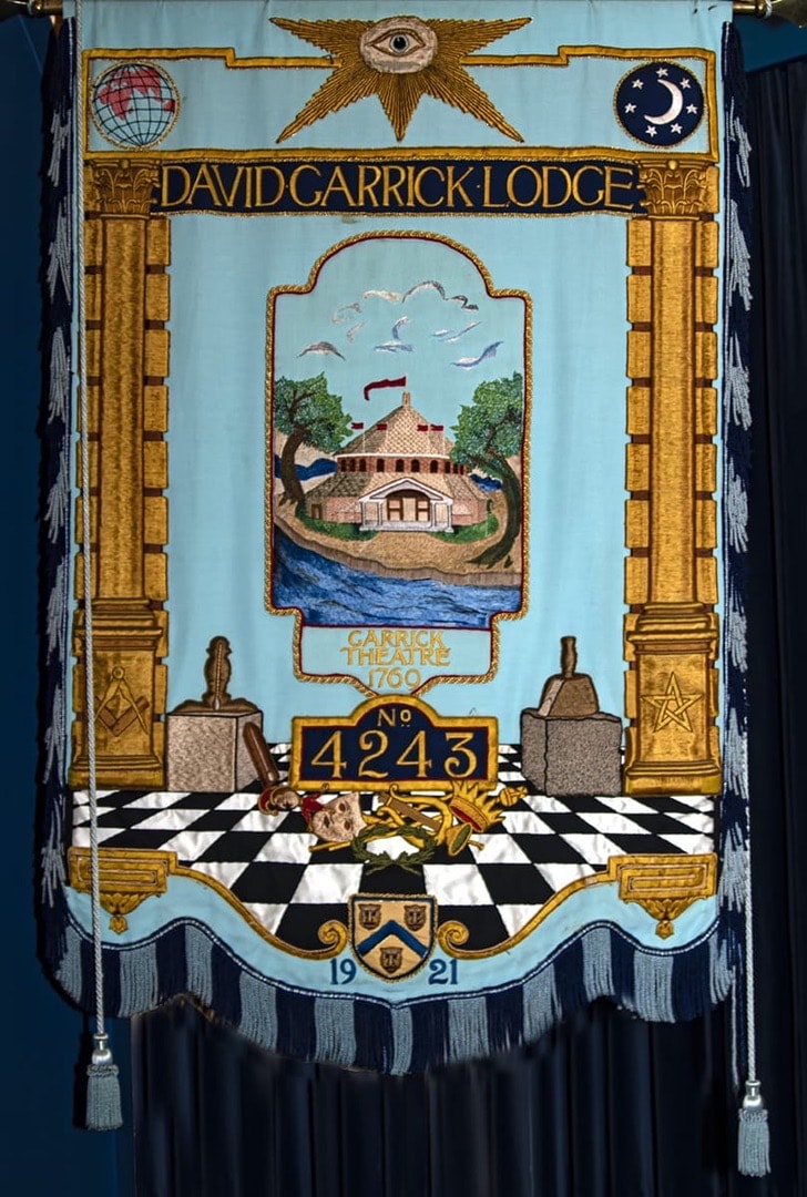 The embroidered banner of David Garrick Lodge No. 4243, crafted in light blue with gold and silver detailing, bearing the lodge name and number beneath the All Seeing Eye
